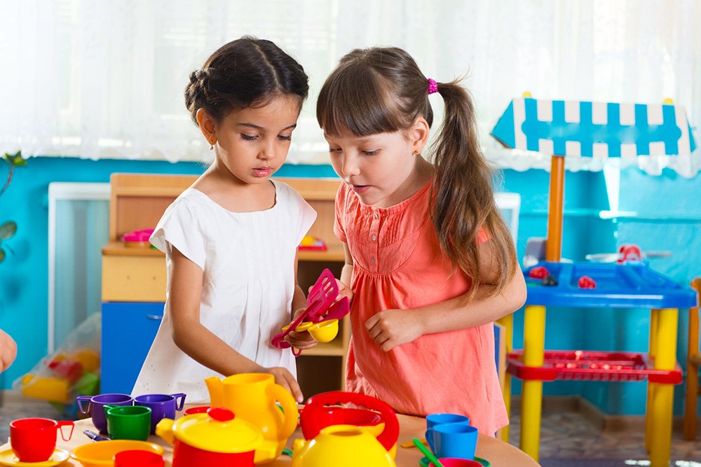 20312243 - two cute little girls playing role game in daycare