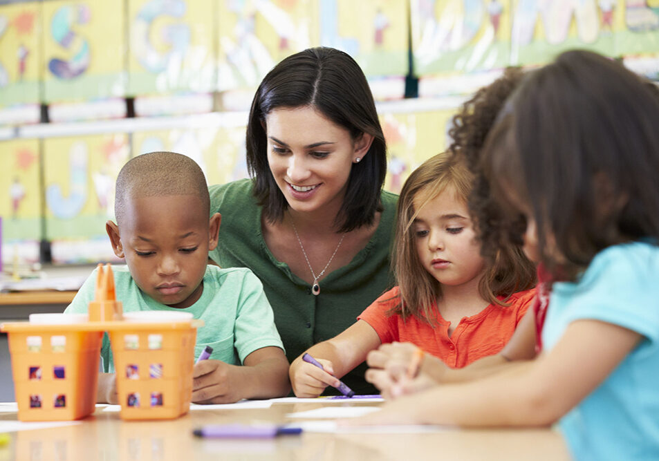 24488422 - group of elementary age children in art class with teacher