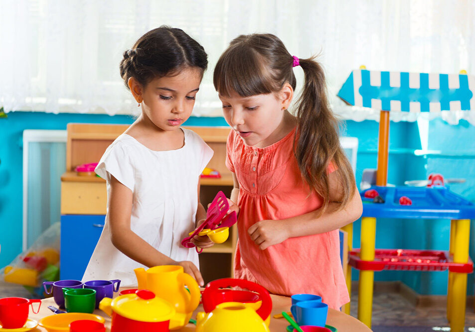 20312243 - two cute little girls playing role game in daycare